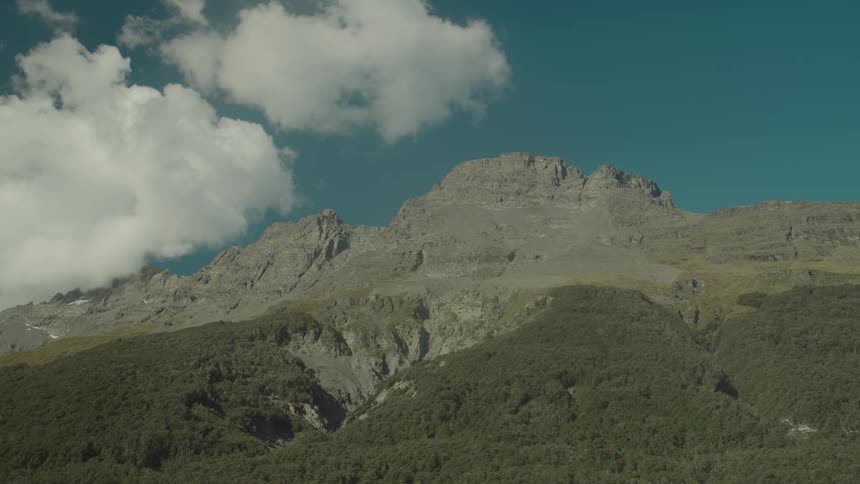 Lush green mountains stretch across the landscape under a clear sky