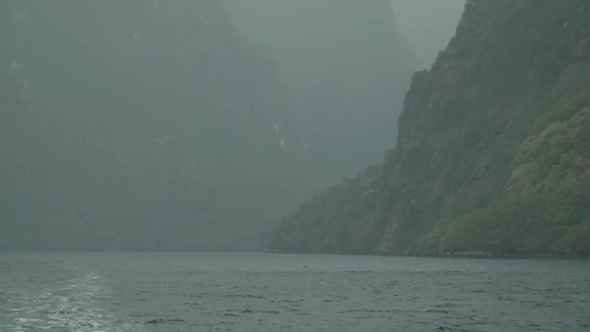 Rain is falling in a body of water that is in the mountains