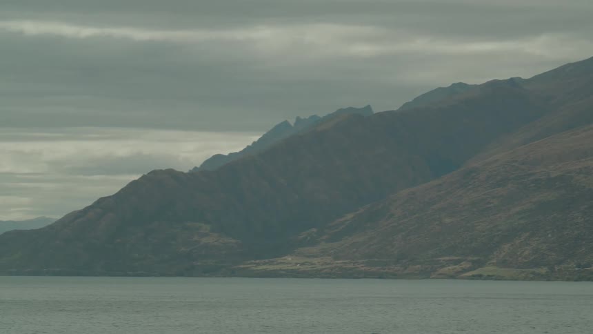 Mountains are shown near a body of water