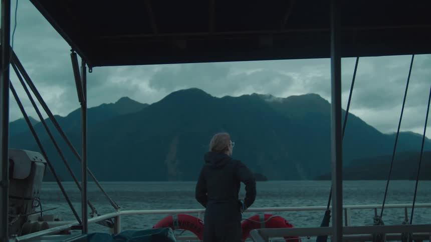 A woman takes a photo on the boat