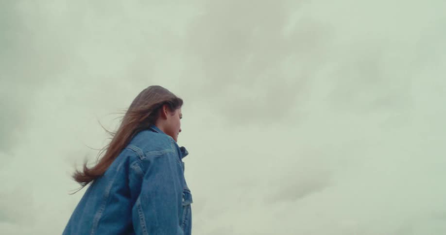 A woman is walking on a windy day