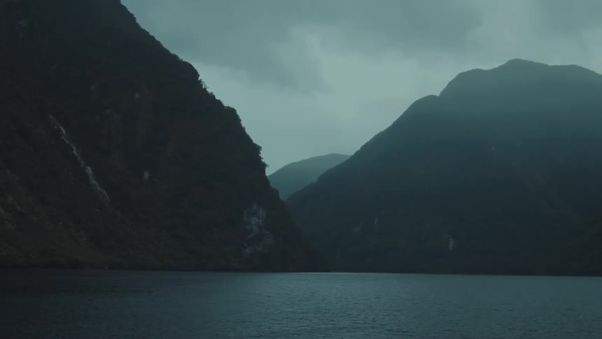 A body of water is positioned against mountains
