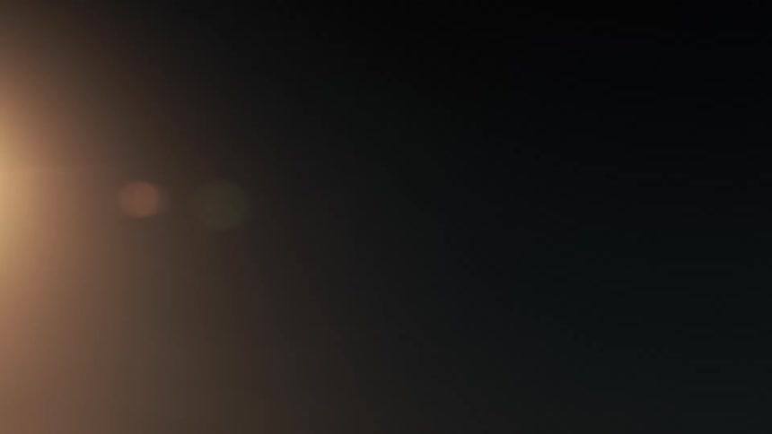 A sphere of light cuts through the black causing a flare
