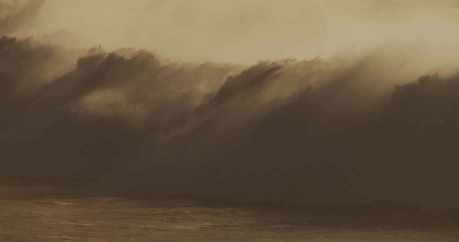 A large waves crashes in the ocean