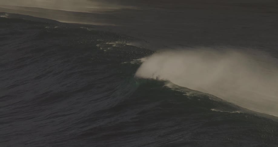 Large waves are throwing spray before they even start to break