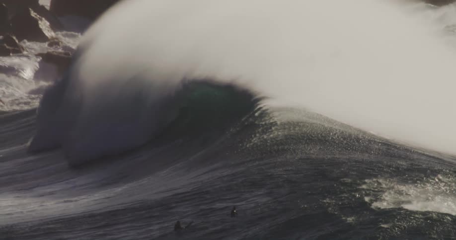 The waves crashes hard against the rocks