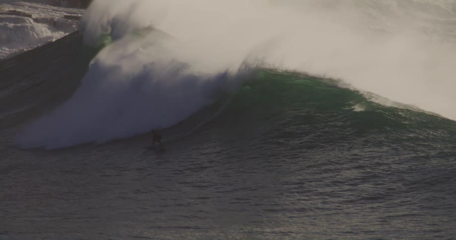 A person surfing the ocean waves at midday