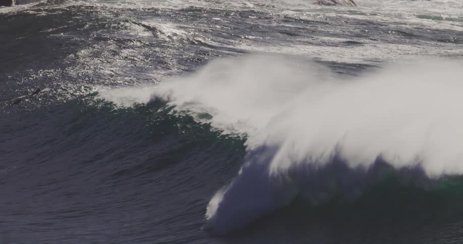 A group of surfers are paddling to the waves