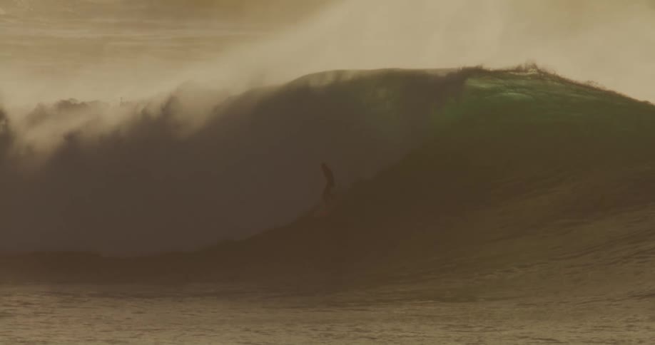 Surfer rides on the slope of a breaking wave