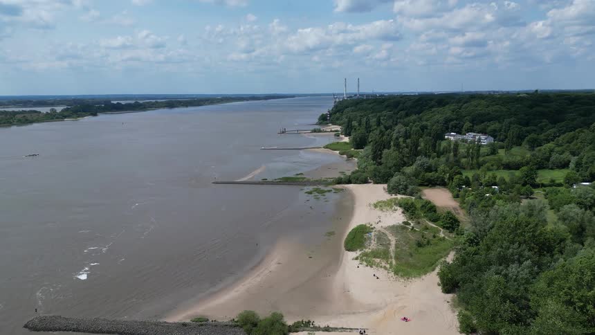 Flying over the land beside a large river