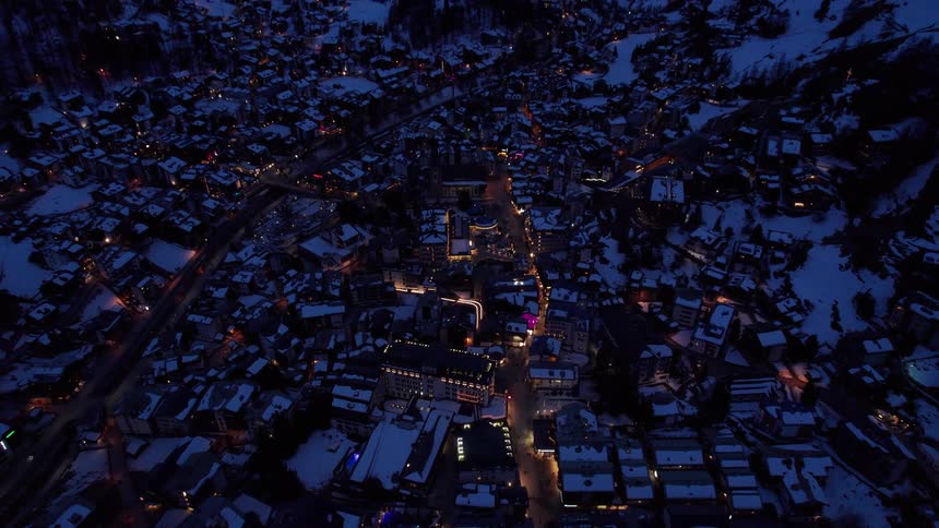 The town and mountains are covered with snow