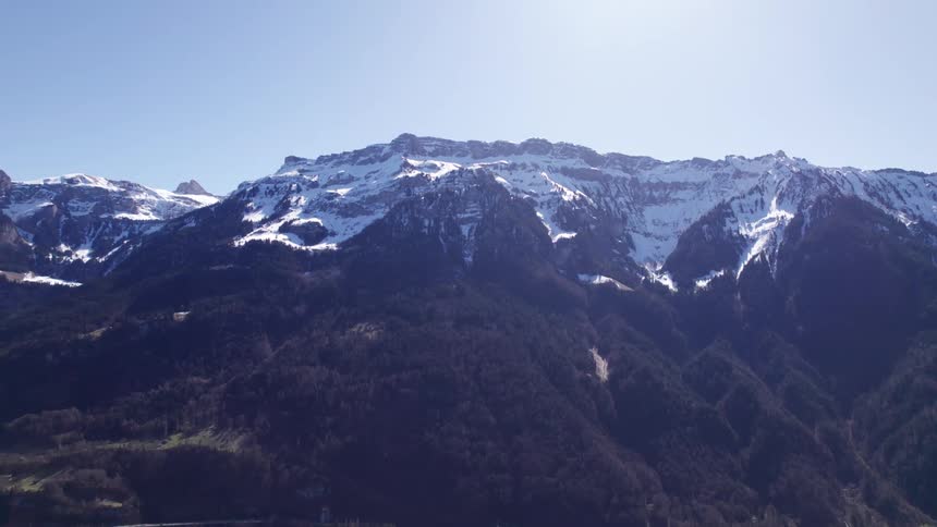 The peak of the tall mountain has some frost