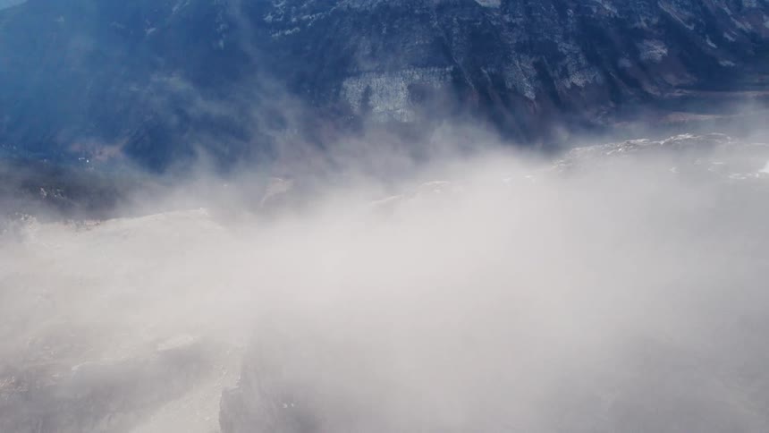 A volcanic mountain was covered in smoke at midday