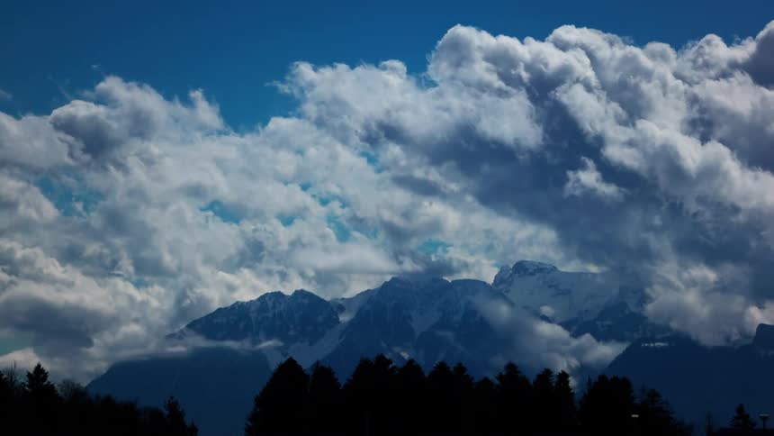 Clouds flow fast over the mountains