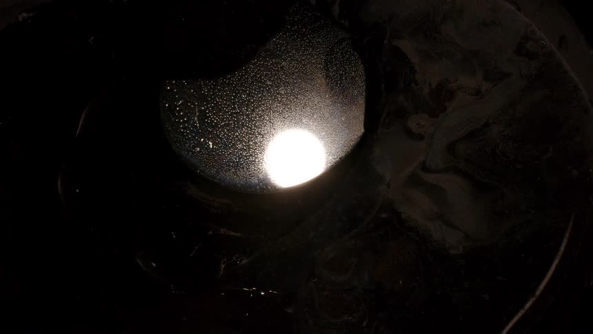 Central core with bright light and dark abstract liquid moving