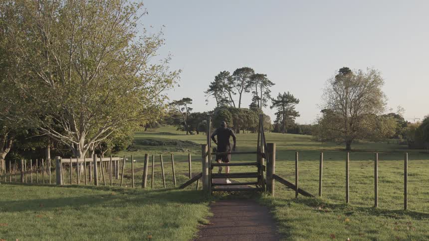 Person crossing a fence in a field