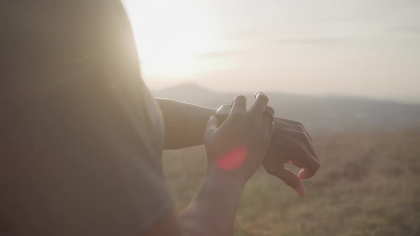 Person outdoors setting up a smartwatch