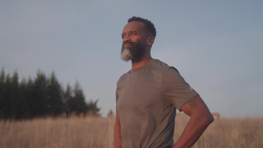 A man stands outside in the breeze