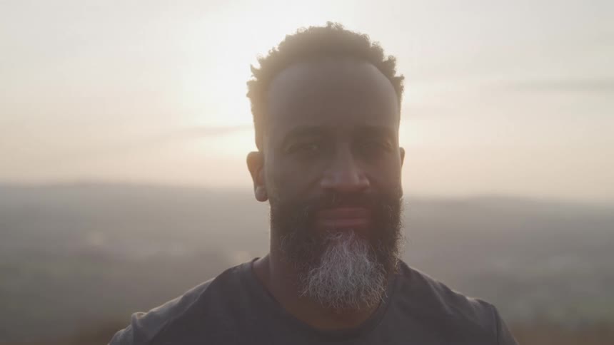 A man stands looking into the camera