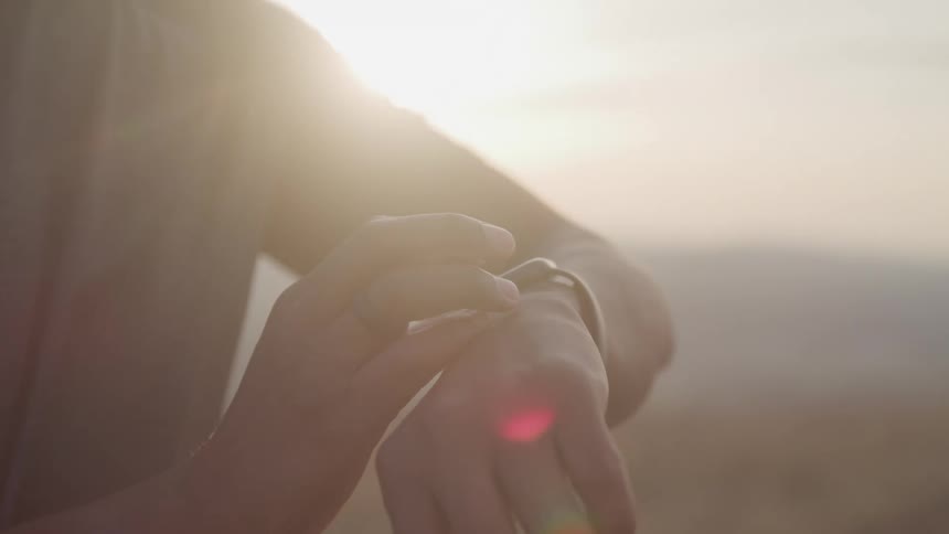 Person setting up a smartwatch on their wrist