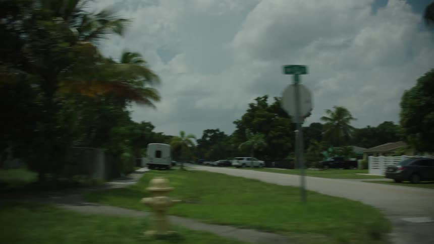 Houses with vehicles parked on a street in a residential neighborhood