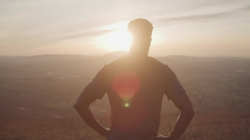 A man takes in a view of the sunrise