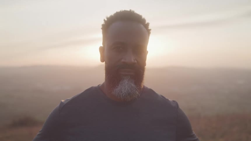 White bearded man with reflection of dawn sun