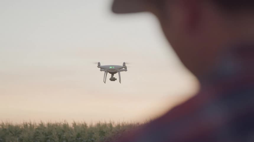 A man controls a flying drone