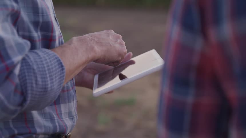 A man is touching the screen of his tablet