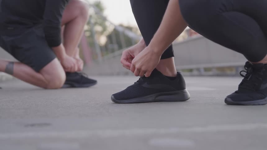 A couple people tie their shoes