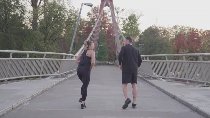 A man and woman jog together