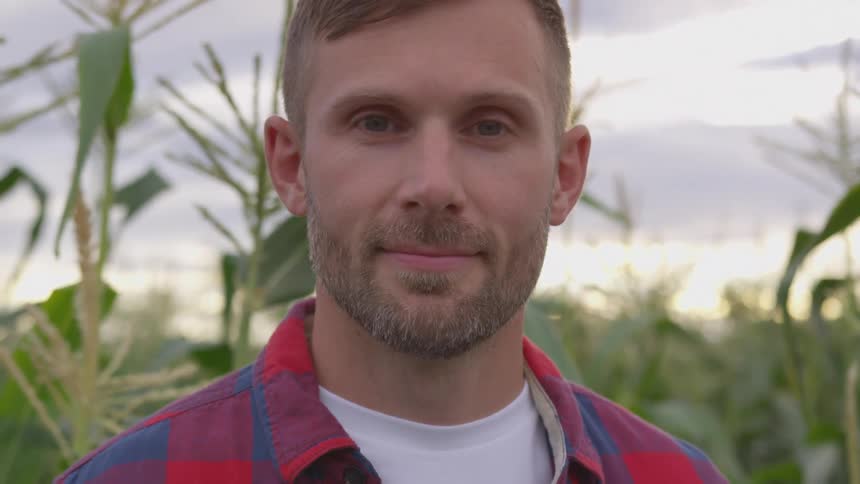 A man raises his head to look at the camera