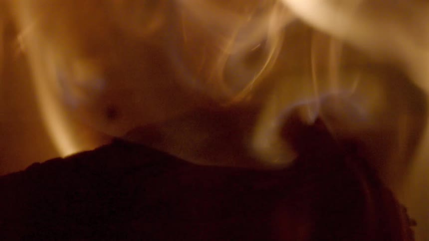 Extreme close up of flames burning and embers rising