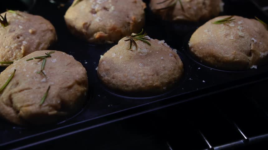 Muffins with spigs on top rising in the oven
