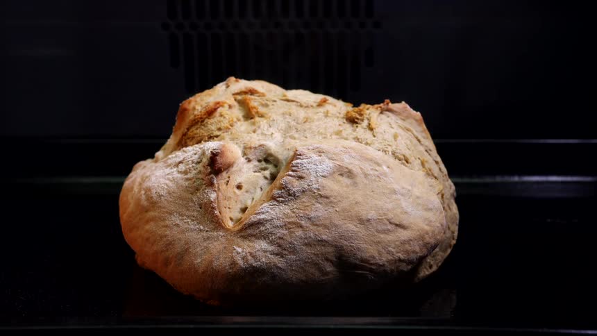 The bread in the oven rises and browns