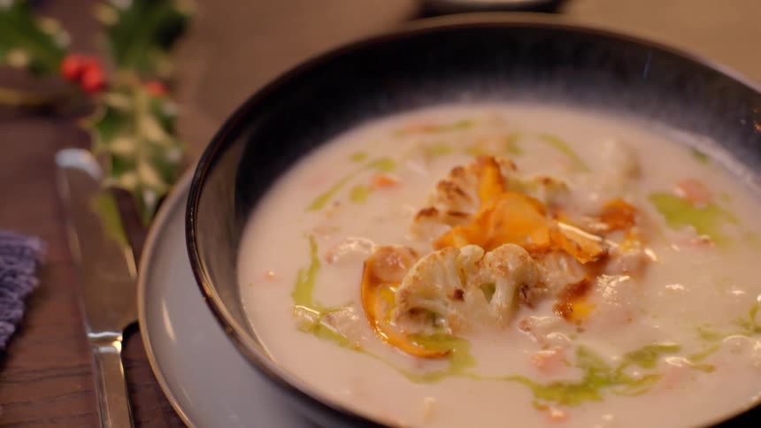 A spoon scoops up some soup