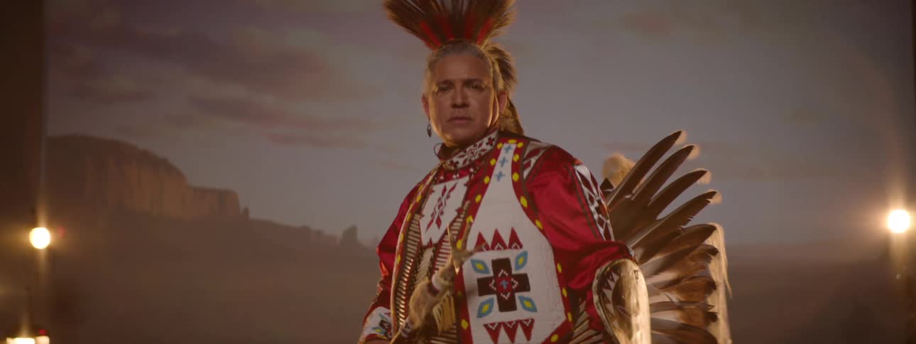 A man is wearing a costume on stage