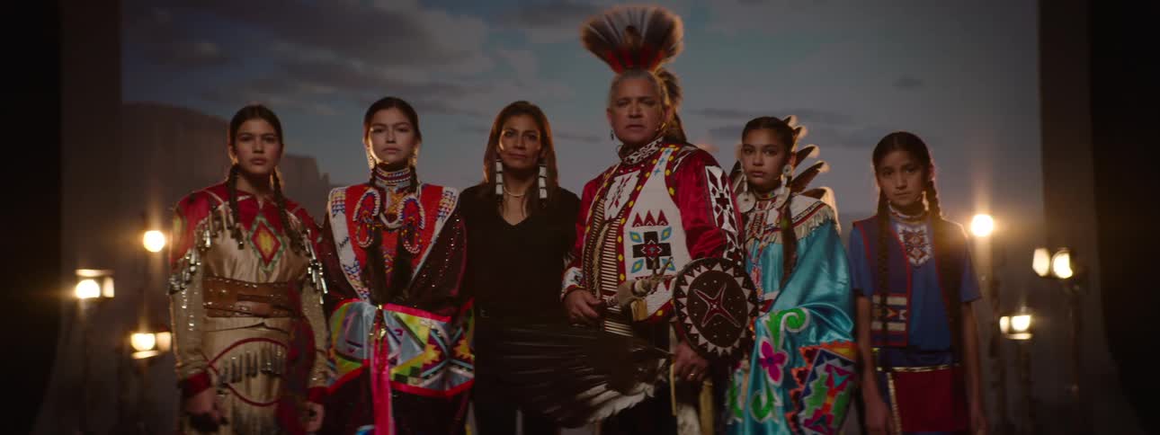 A group of people in costumes are standing side by side