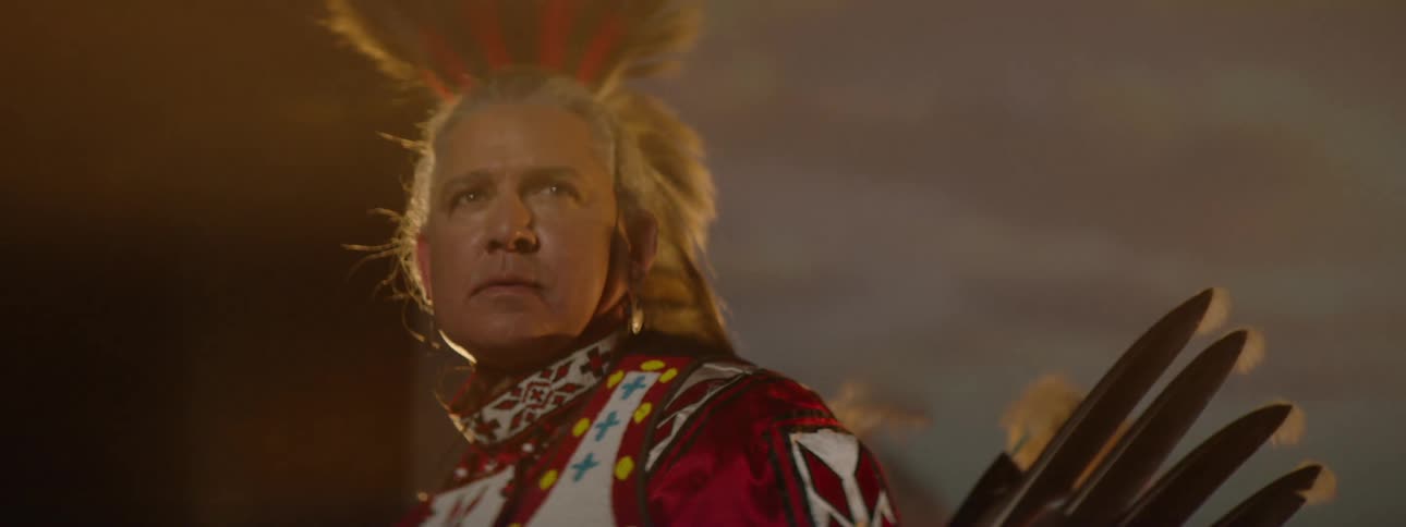 A man is wearing a tribal costume