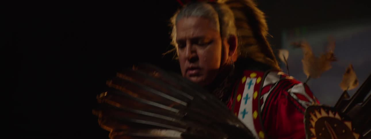 Man dressed in traditional indigenous costume dancing