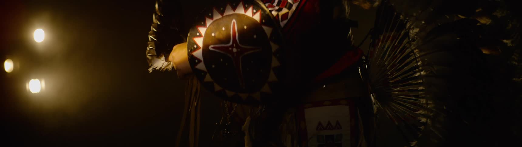 Silhouette of a person performing wearing traditional indigenous clothing