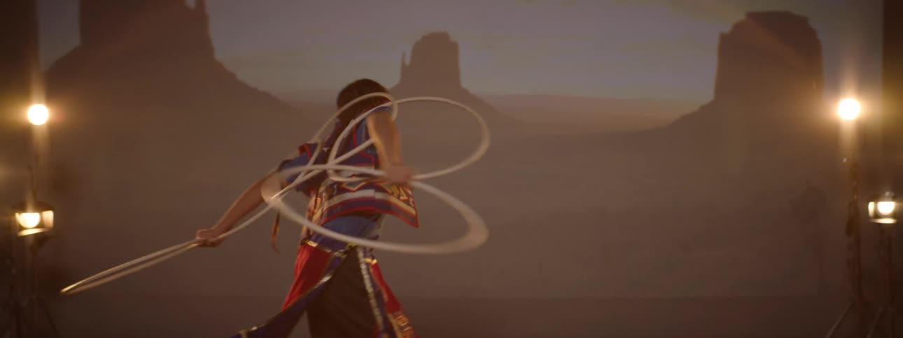 Child dancing solo in a performance wearing traditional indigenous clothing