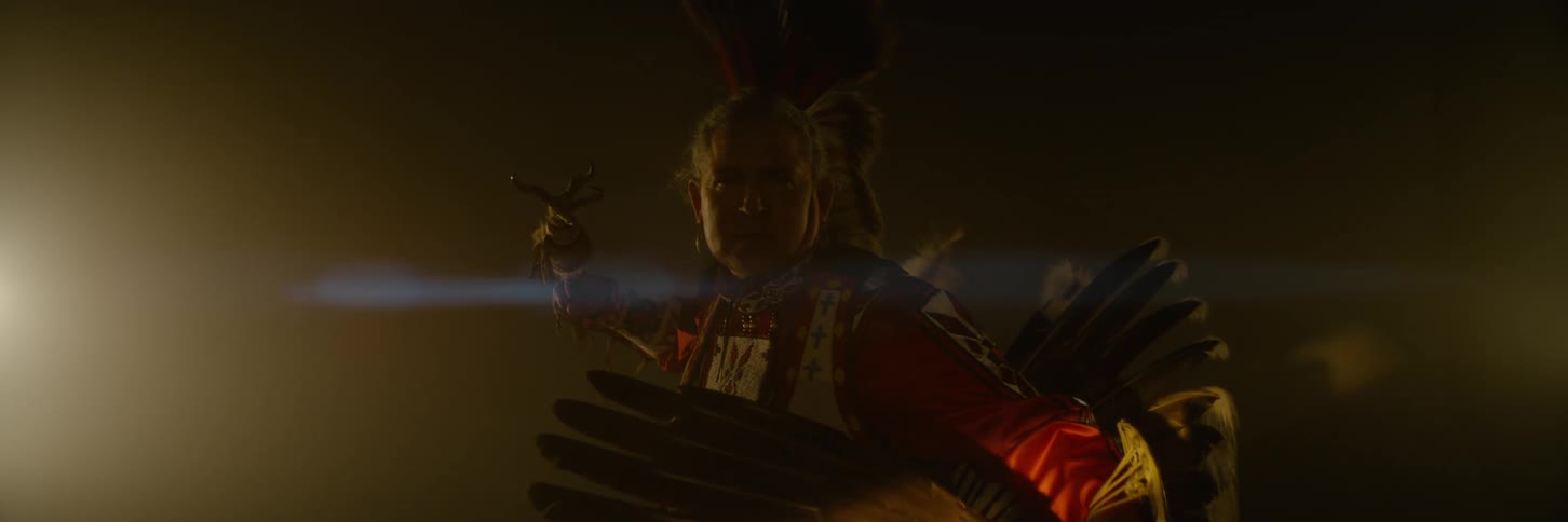 A man wearing a costume is holding a scepter
