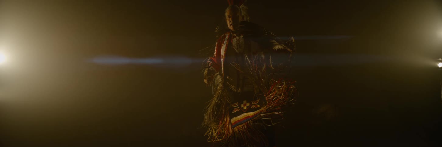 Person in indigenous costume in an indoor environment