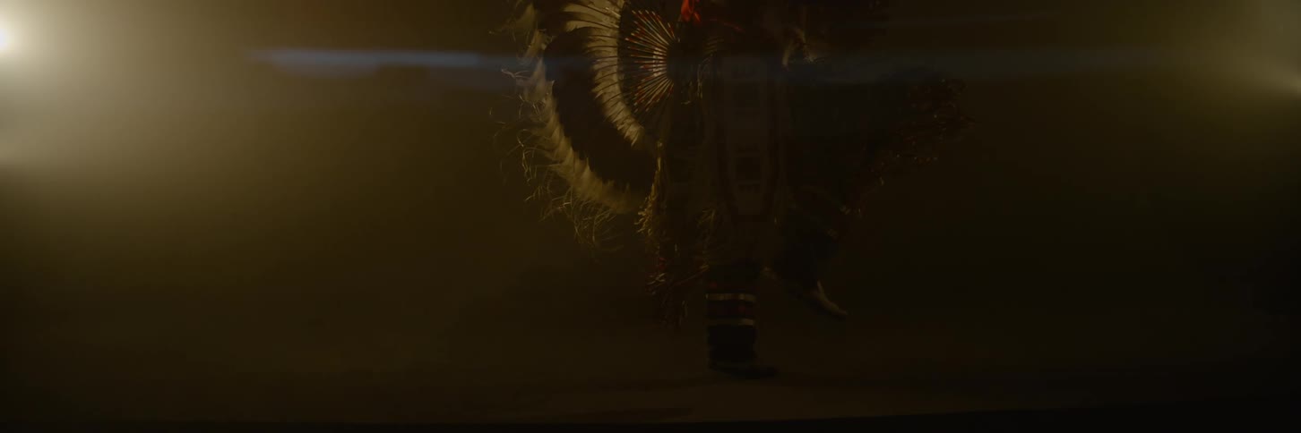 Person dancing in traditional indigenous clothing