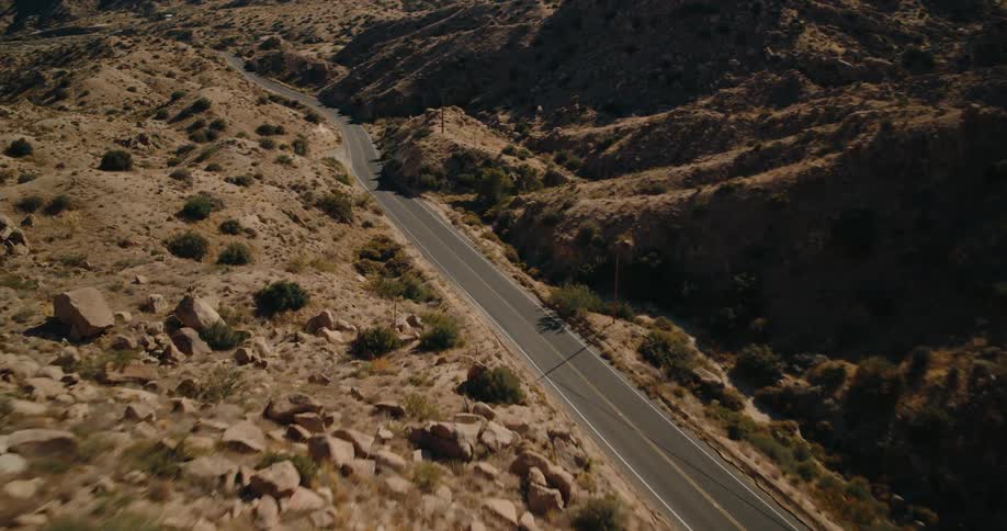 Highway between mountains with sparse vegetation