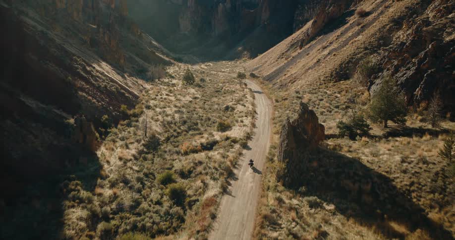 The motorcycle drives by the mountains