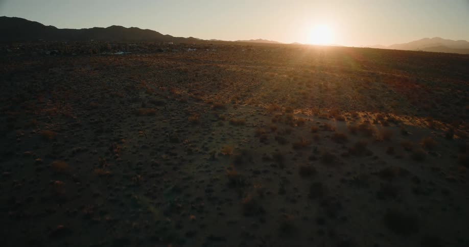 Low aerial view of desert hillside at sunset