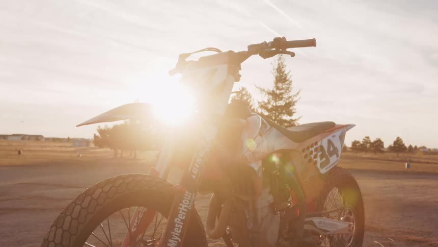 Close up of a stationary sports motorbike in an open field during the day