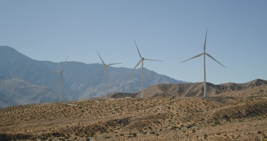 Wind turbines rotating creating energy in the desert